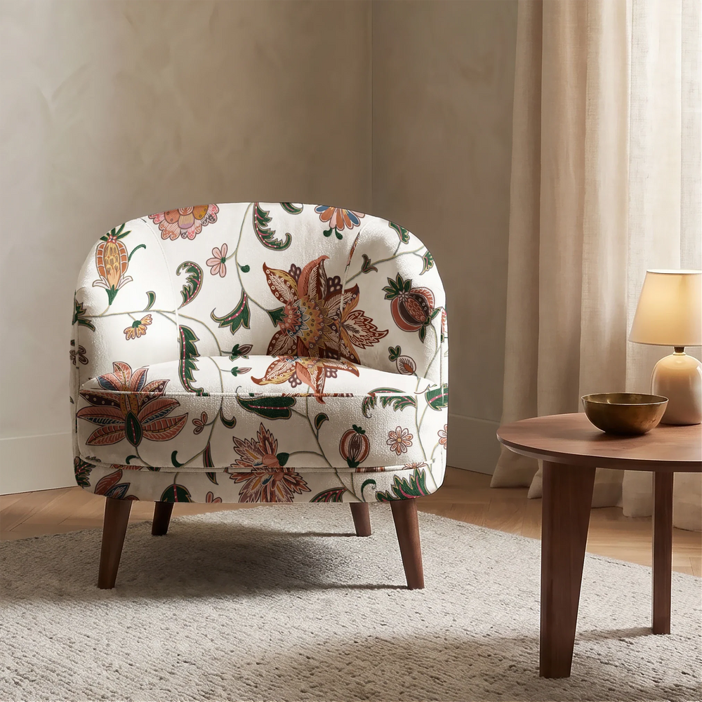Orange and green floral vines on a white ground chenille armchair upholstery mockup.