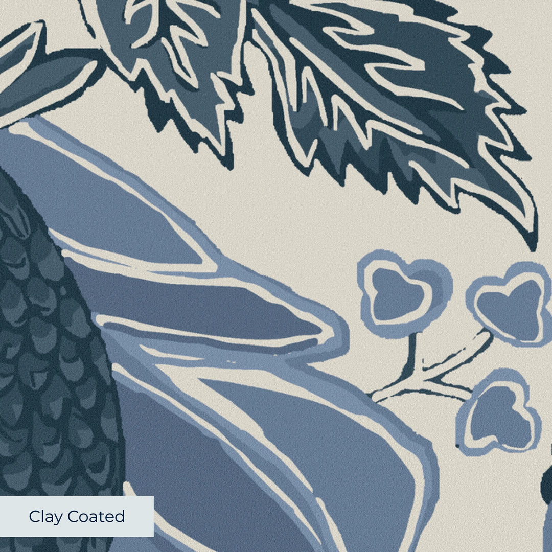 Flowering Pomegranate in linen and dusty blue: an ogee lattice of lace borders framing a blossom held between two swelling pomegranates, translated from an 18th-century French block-printed quilt. clay-coated wallpaper closeup, smooth matte finish