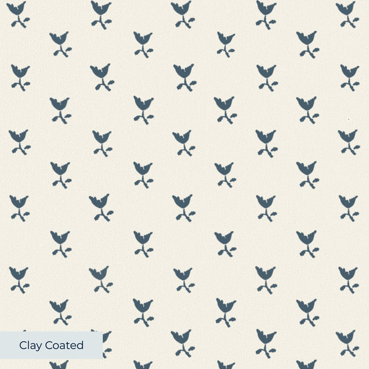 Blue-grey Second Empire tulip silhouette on a warm ivory ground: clay-coated wallpaper closeup, smooth matte finish