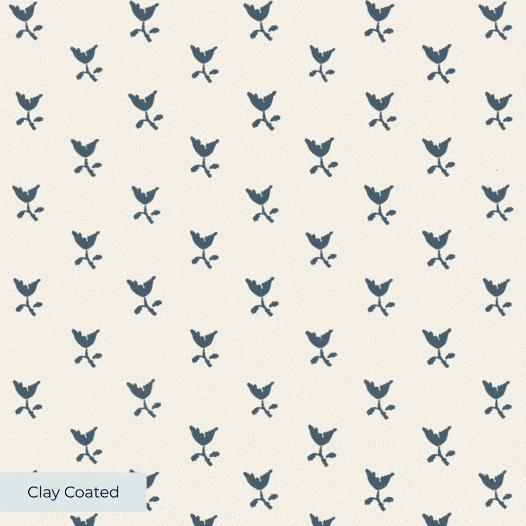 Blue-grey Second Empire tulip silhouette on a warm ivory ground: clay-coated wallpaper closeup, smooth matte finish