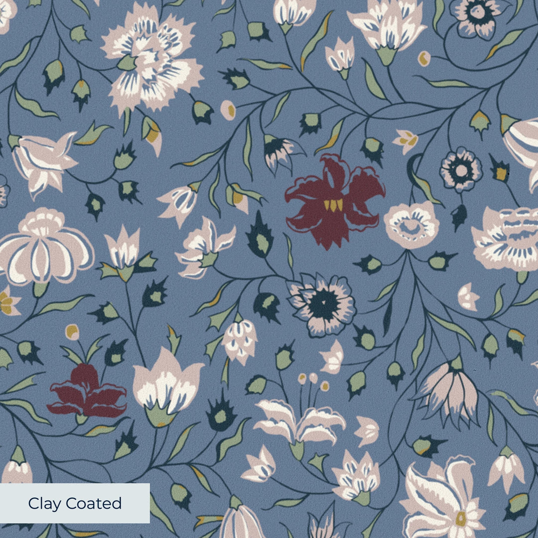 Pink 18th century Indian chintz vine on a muted blue ground: clay-coated wallpaper closeup, smooth matte finish
