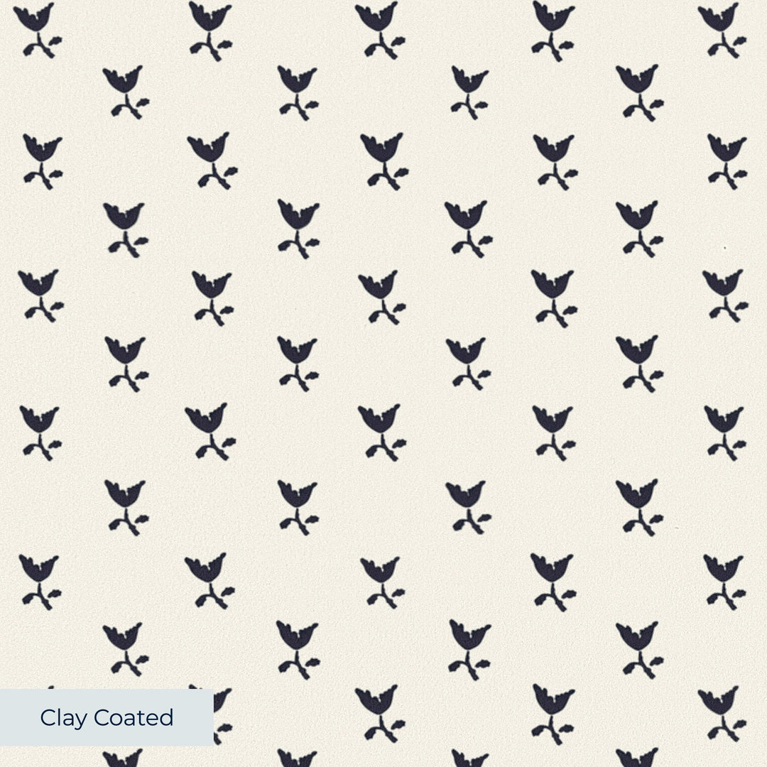 Near-black blue Second Empire tulip silhouette on an ivory ground: clay-coated wallpaper closeup, smooth matte finish