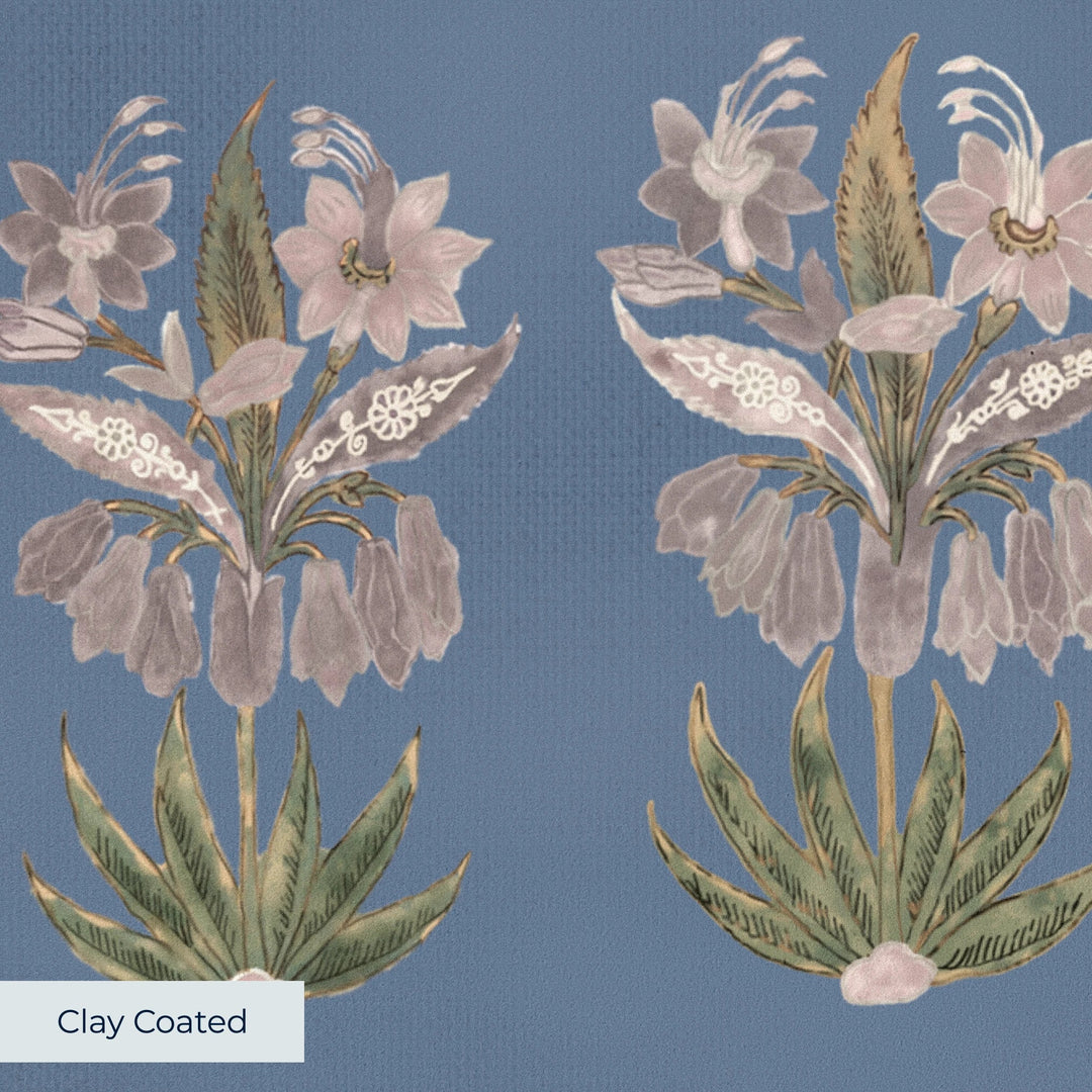 Pink 17th century Indian chintz sprigs on a muted blue ground: clay-coated wallpaper closeup, smooth matte finish