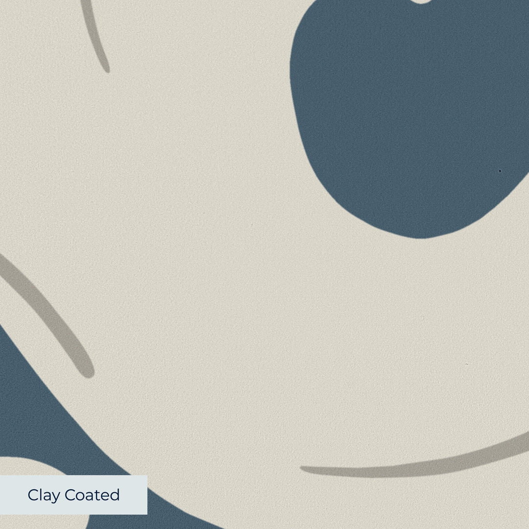 Large beige acanthus scroll motif on a blue ground: clay-coated wallpaper closeup, smooth matte finish
