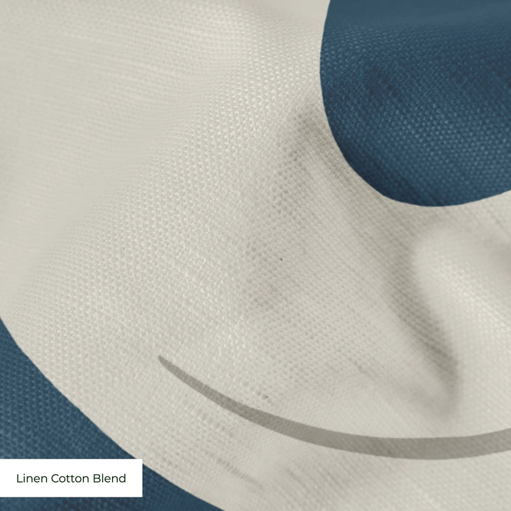 Large beige acanthus scroll motif on a blue ground: linen cotton blend swatch close-up.