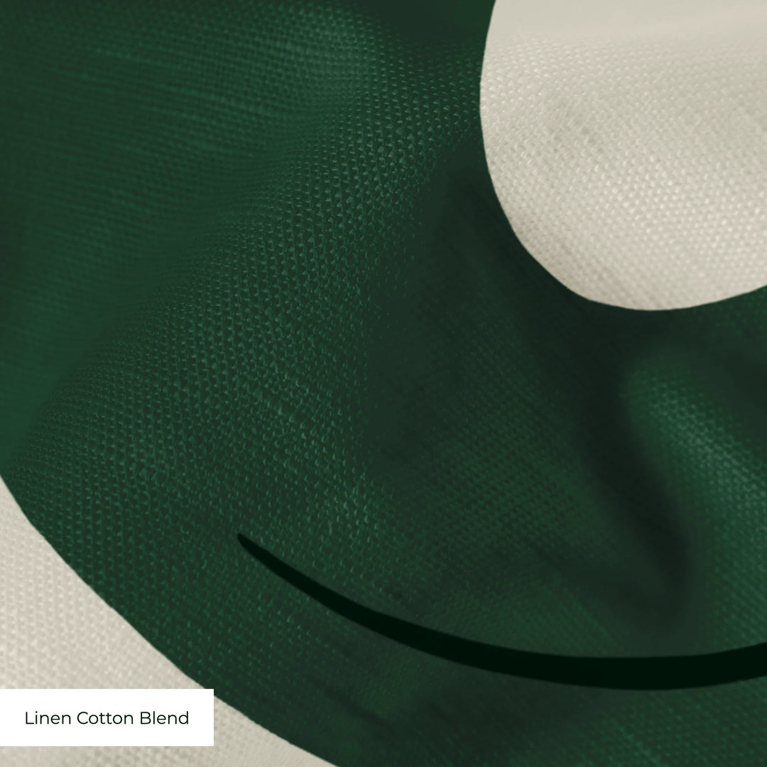 Large green acanthus scroll motif on a beige ground: linen cotton blend swatch close-up.