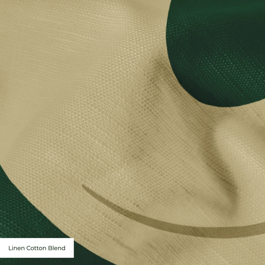 Large gold acanthus scroll motif on a green ground: linen cotton blend swatch close-up.