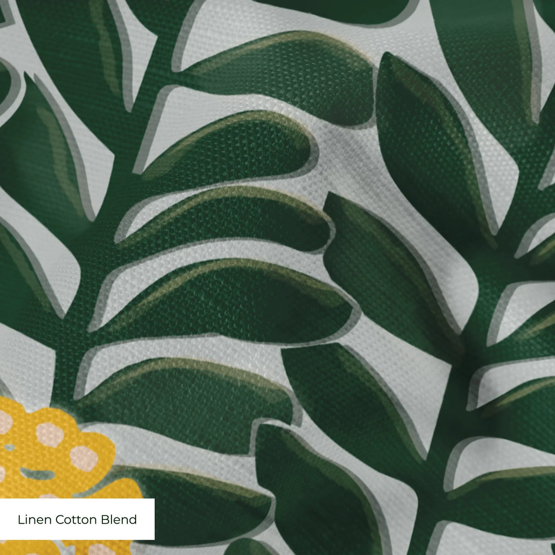 Dark green 1918 leaf sprays with yellow berries on a grey ground: linen cotton blend swatch close-up.