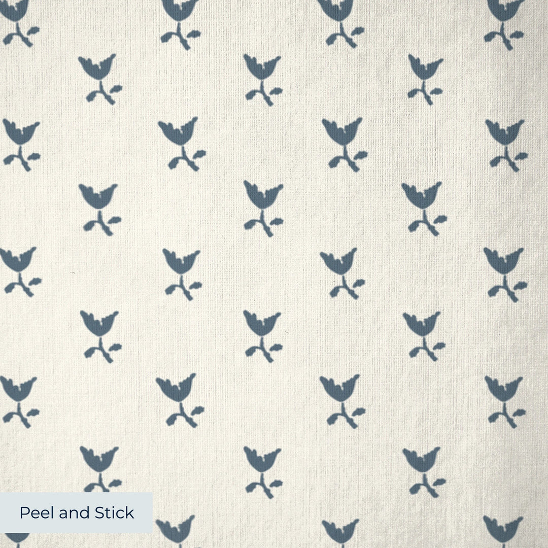Blue-grey Second Empire tulip silhouette on a warm ivory ground: peel-and-stick wallpaper closeup, linen-like texture