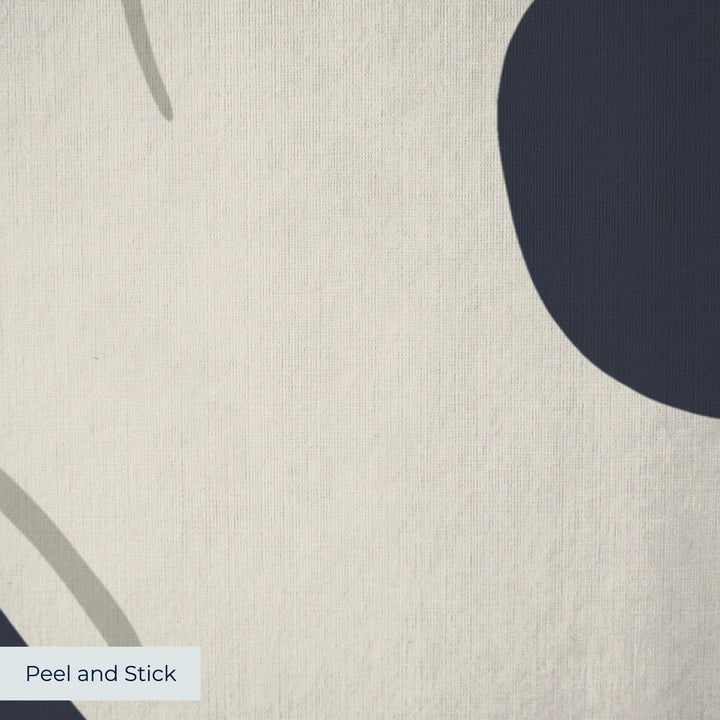 Large beige acanthus scroll motif on a navy ground: peel-and-stick wallpaper closeup, linen-like texture