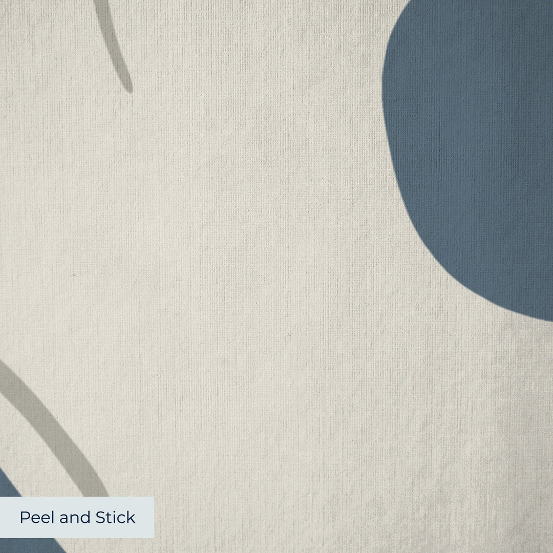Large beige acanthus scroll motif on a blue ground: peel-and-stick wallpaper closeup, linen-like texture