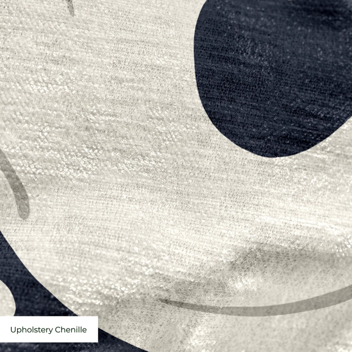 Large beige acanthus scroll motif on a navy ground: upholstery chenille swatch close-up.