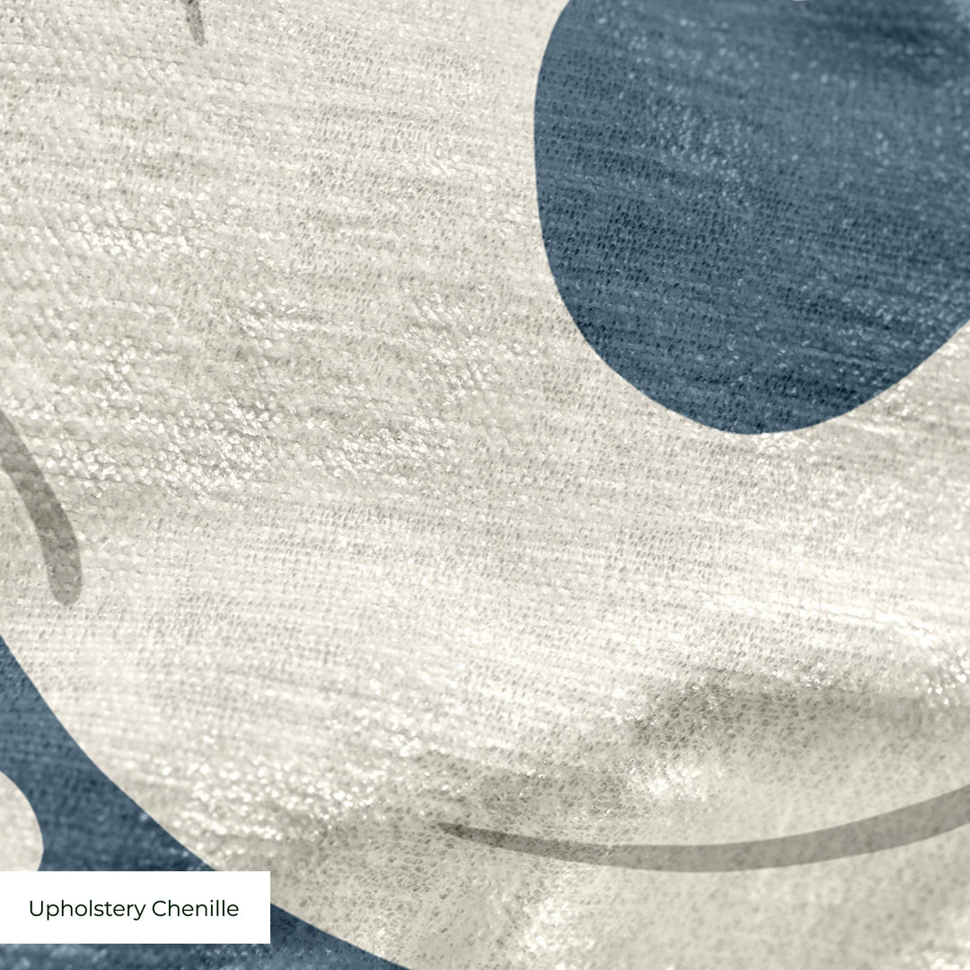 Large beige acanthus scroll motif on a blue ground: upholstery chenille swatch close-up.
