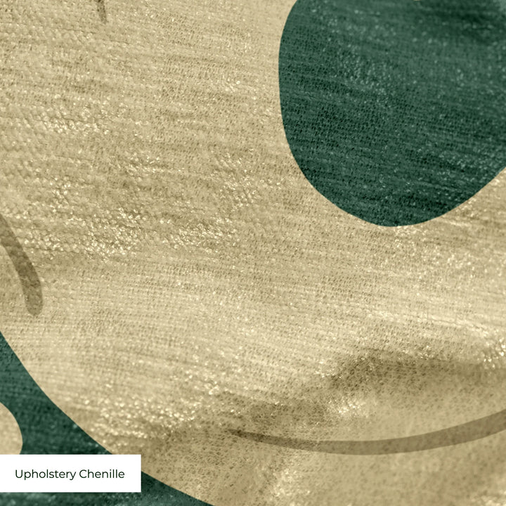 Large gold acanthus scroll motif on a green ground: upholstery chenille swatch close-up.