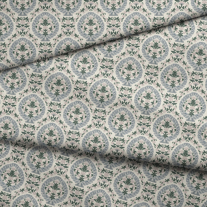 Varanasi Medallion in Ivory and Linen — slate-blue pointed medallions enclosing flowering plants on a near-white ground fabric fold mockup