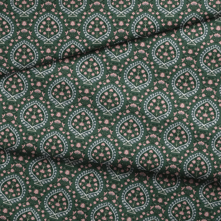 Varanasi Medallion in Forest Floor and Ivory — rose-pink flowers inside pale pointed medallions on a deep green ground fabric fold mockup