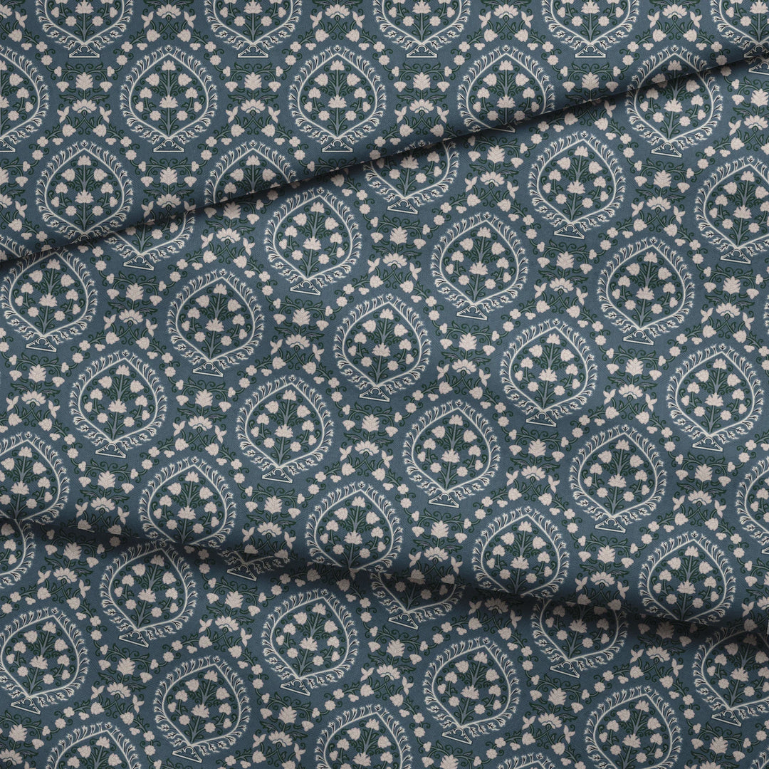 Varanasi Medallion in Slate and Linen — pale flowering plants inside pointed medallions on a cool blue-grey ground fabric fold mockup