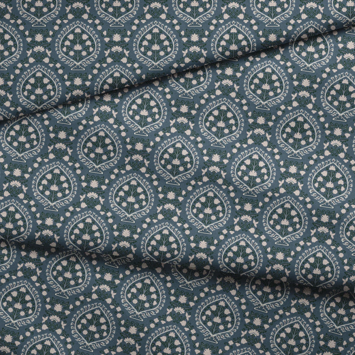 Varanasi Medallion in Slate and Linen — pale flowering plants inside pointed medallions on a cool blue-grey ground fabric fold mockup