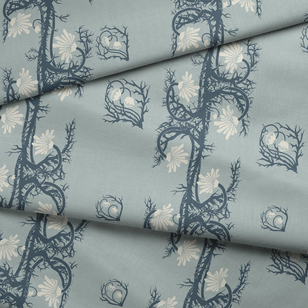 Marguerite in mist and slate: spined, entwined stems forming vertical channels around massed daisy heads, translated from a c. 1904 Dutch linen damask finger towel by Cornelis van der Sluys. fabric fold mockup