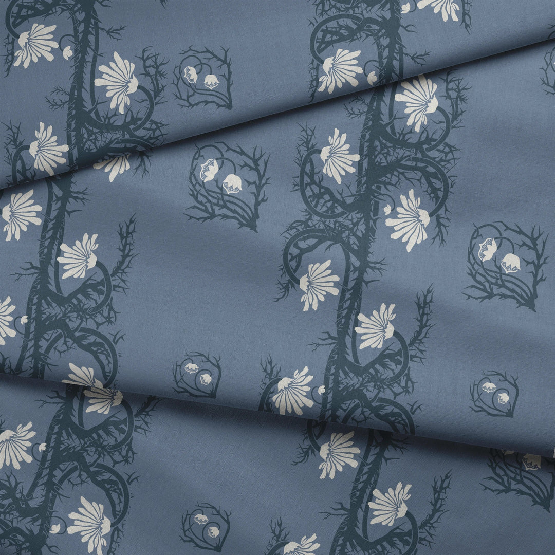 Marguerite in dusty blue and slate: spined, entwined stems forming vertical channels around massed daisy heads, translated from a c. 1904 Dutch linen damask finger towel by Cornelis van der Sluys. fabric fold mockup