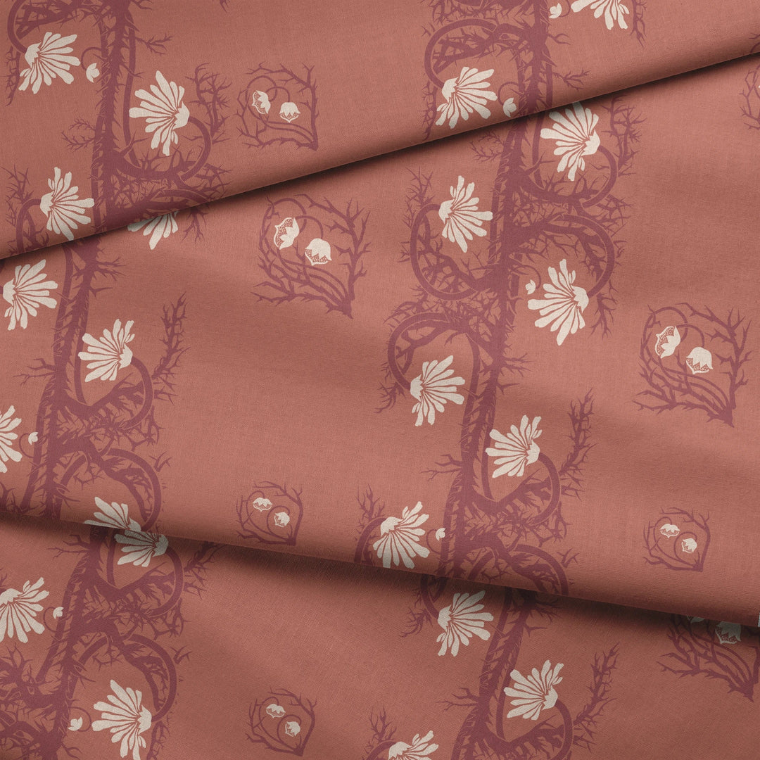 Marguerite in terracotta and pomegranate: spined, entwined stems forming vertical channels around massed daisy heads, translated from a c. 1904 Dutch linen damask finger towel by Cornelis van der Sluys. fabric fold mockup