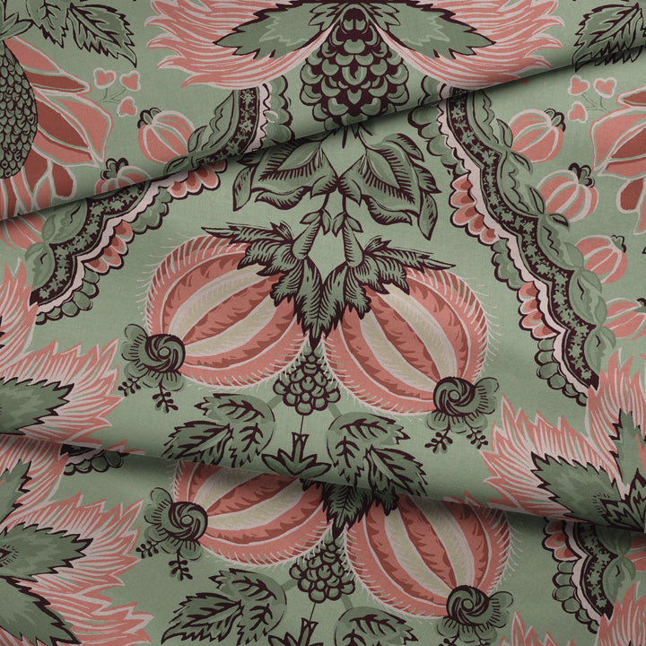 Flowering Pomegranate in eucalyptus and terracotta: an ogee lattice of lace borders framing a blossom held between two swelling pomegranates, translated from an 18th-century French block-printed quilt. fabric fold mockup