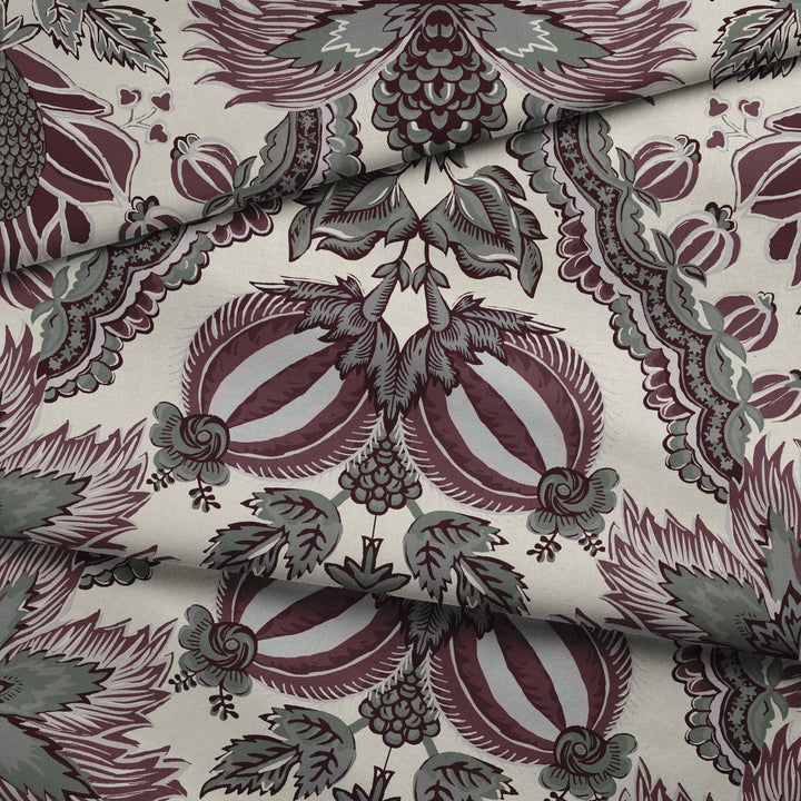 Flowering Pomegranate in linen and blackcurrant: an ogee lattice of lace borders framing a blossom held between two swelling pomegranates, translated from an 18th-century French block-printed quilt. draped fabric fold preview.