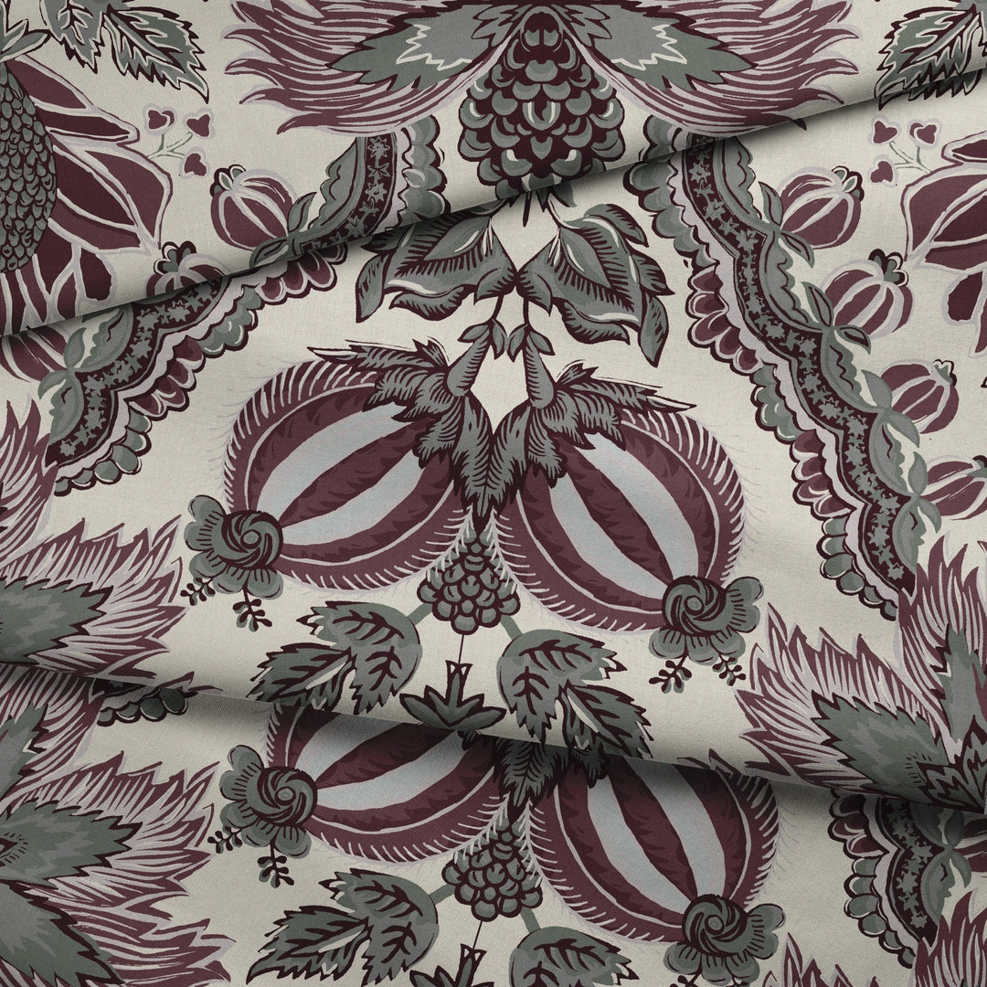 Flowering Pomegranate in linen and blackcurrant: an ogee lattice of lace borders framing a blossom held between two swelling pomegranates, translated from an 18th-century French block-printed quilt. draped fabric fold preview.