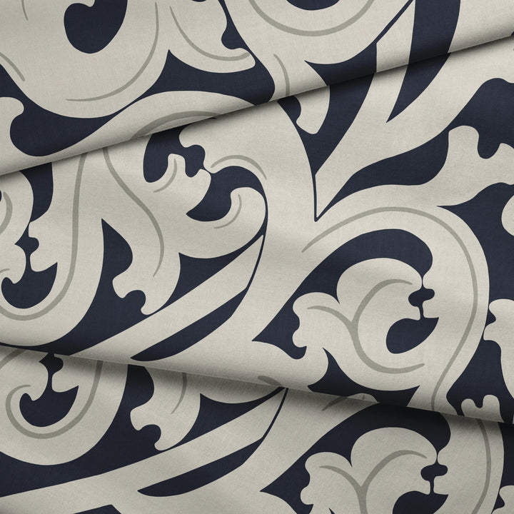 Large beige acanthus scroll motif on a navy ground: draped fabric fold preview.