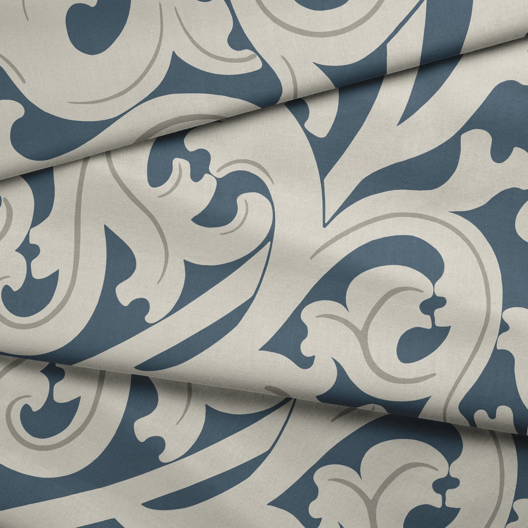 Large beige acanthus scroll motif on a blue ground: draped fabric fold preview.