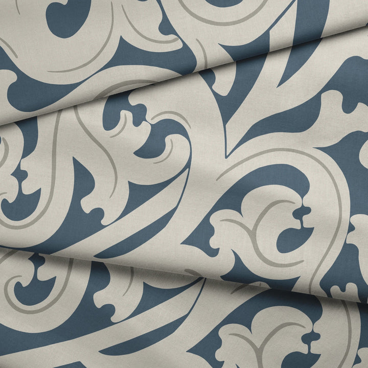 Large beige acanthus scroll motif on a blue ground: draped fabric fold preview.