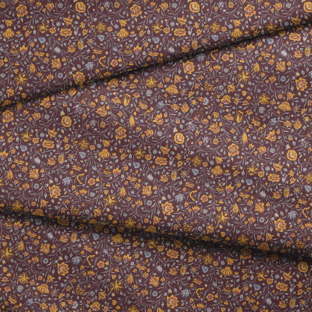 Yellow 18th century Indian chintz vine on a dark purple ground: draped fabric fold preview.