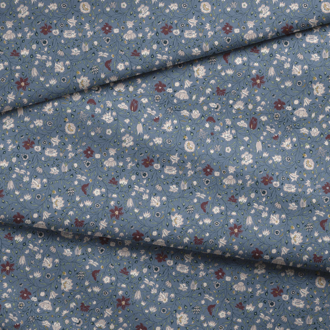 Pink 18th century Indian chintz vine on a muted blue ground: draped fabric fold preview.