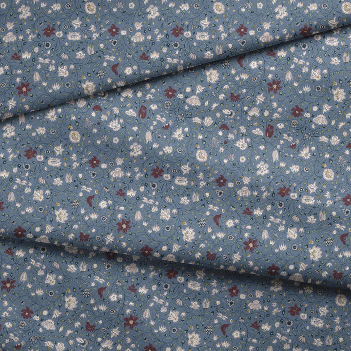 Pink 18th century Indian chintz vine on a muted blue ground: draped fabric fold preview.