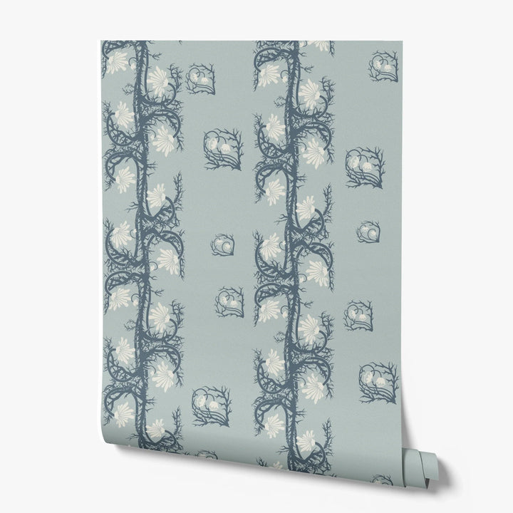 Marguerite in mist and slate: spined, entwined stems forming vertical channels around massed daisy heads, translated from a c. 1904 Dutch linen damask finger towel by Cornelis van der Sluys. printed wallpaper roll