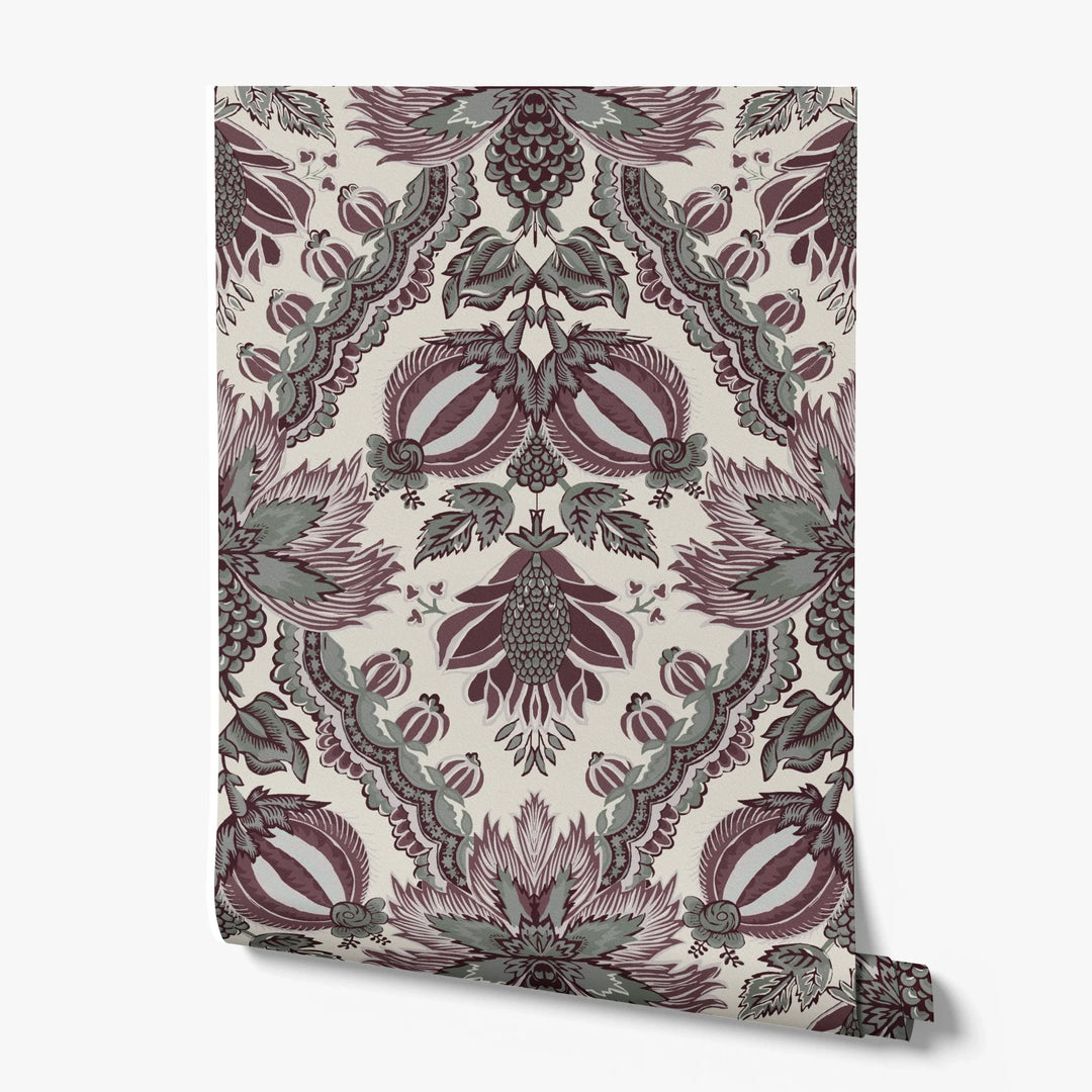 Flowering Pomegranate in linen and blackcurrant: an ogee lattice of lace borders framing a blossom held between two swelling pomegranates, translated from an 18th-century French block-printed quilt. printed wallpaper roll
