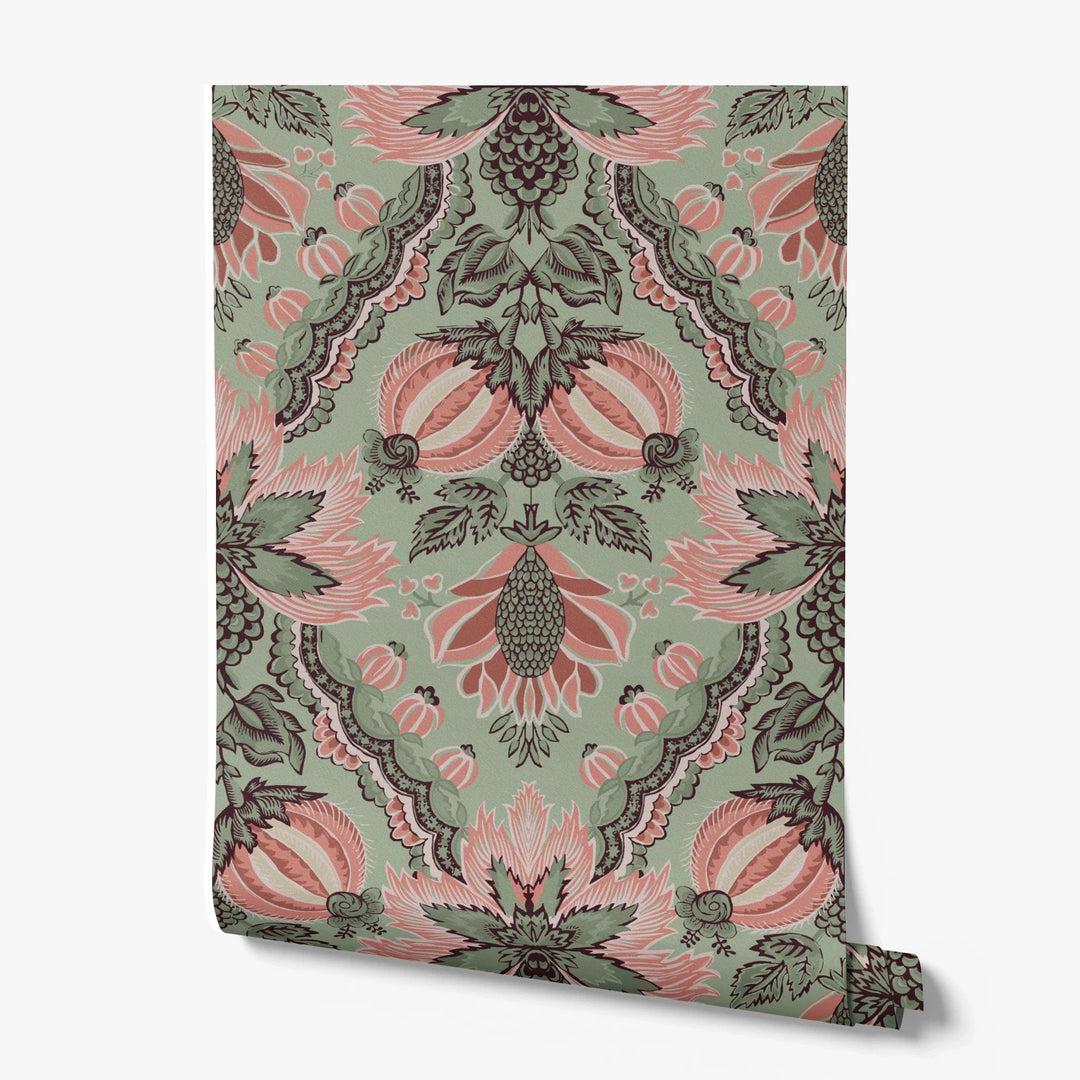 Flowering Pomegranate in eucalyptus and terracotta: an ogee lattice of lace borders framing a blossom held between two swelling pomegranates, translated from an 18th-century French block-printed quilt. printed wallpaper roll