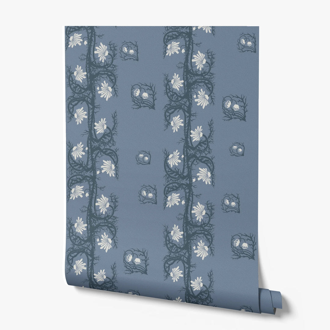 Marguerite in dusty blue and slate: spined, entwined stems forming vertical channels around massed daisy heads, translated from a c. 1904 Dutch linen damask finger towel by Cornelis van der Sluys. printed wallpaper roll